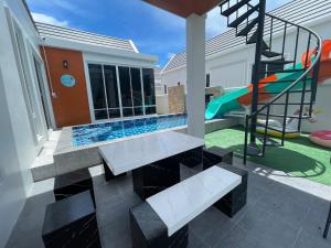 a backyard with a slide and a playground at ATPoolVillaHuaHin เอทีพูลวิลล่าหัวหิน in Ban Wang Bot
