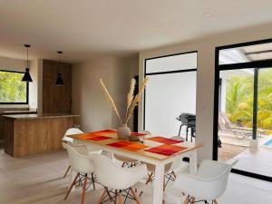 a dining room with a table and white chairs at Casa Bellota in Marbella