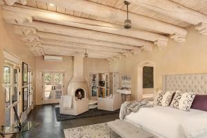 a living room with a bed and a fireplace at Villa Namaste-Mountain View Home in Santa Fe