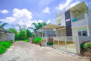 une maison blanche avec terrasse couverte à côté d'un bâtiment dans l'établissement Villa 17 Celcius Private Pool and Rooftop, à Tlekung