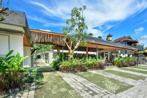 an exterior view of a house with a garden at Mahayoga Ubud Private Pool Villa And Spa in Ubud