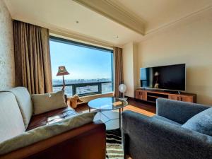 a living room with a couch and a large window at 台中自由行 in Taichung