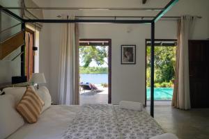 a bedroom with a bed and a view of the water at Minnehaha Bentota in Bentota