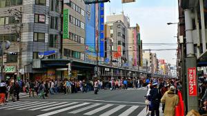 a crowd of people crossing a street in a busy city at Toyoko Inn Osaka Namba Nippombashi in Osaka