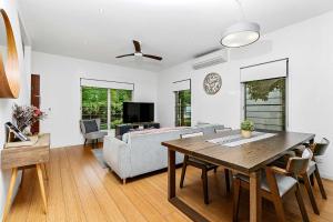 a living room with a table and a couch at Beachfront Nirvana in Urangan