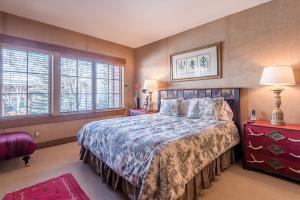 a bedroom with a bed and two windows at Westridge Condo 27 - Cozy Condo Walk to Bald Mt and Downtown Ketchum in Ketchum