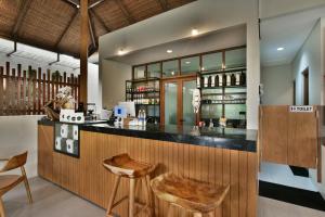 a bar in a restaurant with two stools at Mahayoga Ubud Private Pool Villa And Spa in Ubud