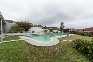 a swimming pool in the backyard of a house at 11 On Glengarry With A Pool in Gqeberha