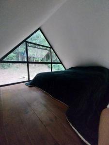 Uma cama ou camas num quarto em Chalé da Colina Florianópolis