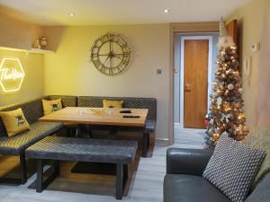 a dining room with a table and a christmas tree at The Hive in Newcastle upon Tyne