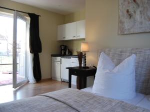 a bedroom with a bed with a white pillow and a table at Ferienwohnung Hiddensee in Vitte in Vitte