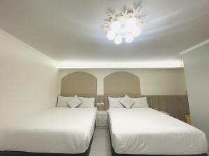 Rúm í herbergi á Xiong Zhi Mi B&B