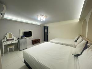 Rúm í herbergi á Xiong Zhi Mi B&B