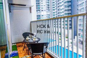 a balcony with a table and chairs on a balcony at Lovely Family Suites at Razak City Residence KL by HCK in Kuala Lumpur