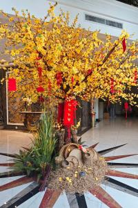 a large tree with yellow leaves and red bows at Tuong Vi Corner in Ho Chi Minh City