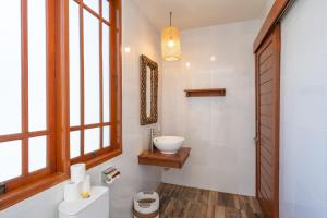 a bathroom with a sink and a toilet and a window at Villa WES - Legian - 5 Bedroom - 4 Bath - Location in Seminyak +20 photos
