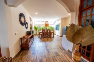 a living room with a wooden floor and a dining room at Villa WES - Legian - 5 Bedroom - 4 Bath - Location in Seminyak