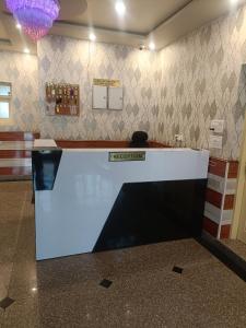 a lobby with a reception counter in a building at Hotel Nouvella Residency in Srinagar