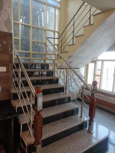 a spiral staircase in a building with a window at Hotel Nouvella Residency in Srinagar
