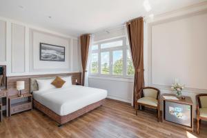 Postel nebo postele na pokoji v ubytování PINE VIEW Hotel Dalat