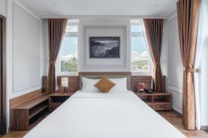 Postel nebo postele na pokoji v ubytování PINE VIEW Hotel Dalat