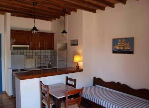 a kitchen with a table and a table and a dining room at Mealos Apartments in Skiros +52 photos