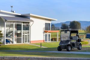 a golf cart parked in front of a building at Springs Shoalhaven Nowra in Nowra