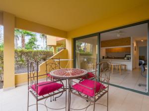a patio with a table and chairs on a balcony at Casa Tindaya - 5 min walk from the Sea in Corralejo