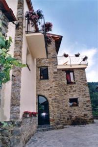 a stone building with a balcony and a door at B&b Il Tulipano in Polverara
