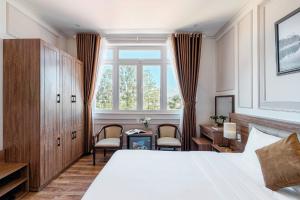 Postel nebo postele na pokoji v ubytování PINE VIEW Hotel Dalat