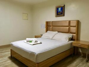 a bedroom with a large bed with a tray on it at Meaco Royal Hotel - Valenzuela in Manila