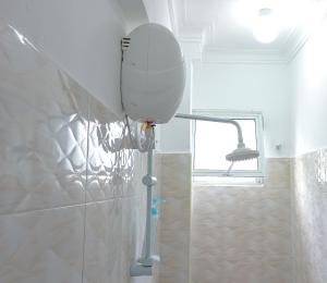 a bathroom with a shower with a mirror on the wall at Seaside Heights 2BR 43' Smart TV in Mombasa