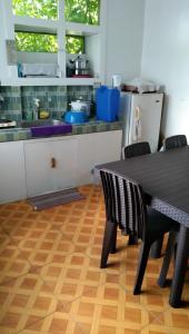 a kitchen with a table and chairs in a kitchen at Havilah House Baguio City in Baguio