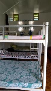 a couple of bunk beds in a room at Havilah House Baguio City in Baguio