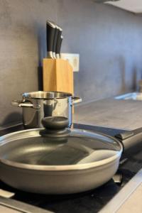 a pan sitting on top of a stove with a pot at ApartHome - LUXUS PUR auf 91m2 Klima in Eching