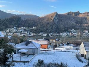 a town covered in snow with mountains in the background at Chez Gwen et Marie in Bogny Sur Meuse