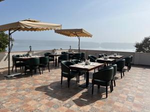 a restaurant with tables and chairs on a patio at Narwar Lakefront Resort in Shivpurī
