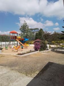 a playground with a slide in a park at HILLOCK BUNGALOW KUTTIKKANAM in Idukki