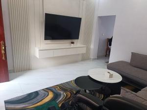 a living room with a couch and a tv at NM Homestay in Kampot
