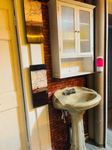 a bathroom with a white sink and a mirror at Penthouse TJ in Tijuana