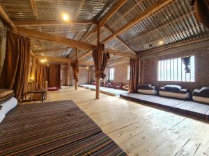 Habitación grande con sofás y techo de madera. en Nhà Cổ Lao Xa Homestay Hmong & Bungalow air conditioner, en Dồng Văn