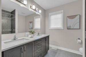 a white bathroom with a sink and a mirror at Luxurious and Beautiful, Ottawa in Ottawa +25 photos