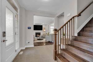 a hallway with stairs and a living room at Luxurious and Beautiful, Ottawa in Ottawa