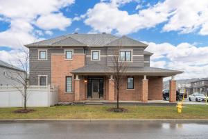 a brick house with a gray roof at Luxurious and Beautiful, Ottawa in Ottawa