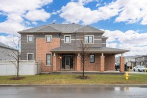 a brick house with a gray roof at Luxurious and Beautiful House in Ottawa