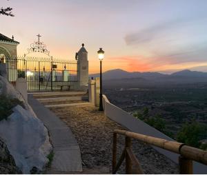 a street light on the side of a hill with a sunset at Apto-Estudio 20 min-centro Málaga in Cártama