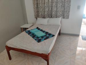 a small bed in a room with a window at Mandurah's Inn, Malapascua in Malapascua Island