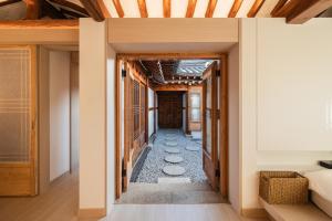 a hallway of a house with stepping stones on the floor at Luxury hanok with private bathtub - SN18 in Seoul