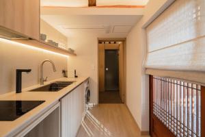 a kitchen with a sink and a dishwasher at Luxury hanok with private bathtub - SN18 in Seoul