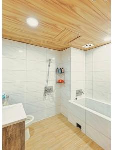 a bathroom with a shower and a tub and a sink at 知本富爺飯店Chihpen Fuye Hotel in Wenquan